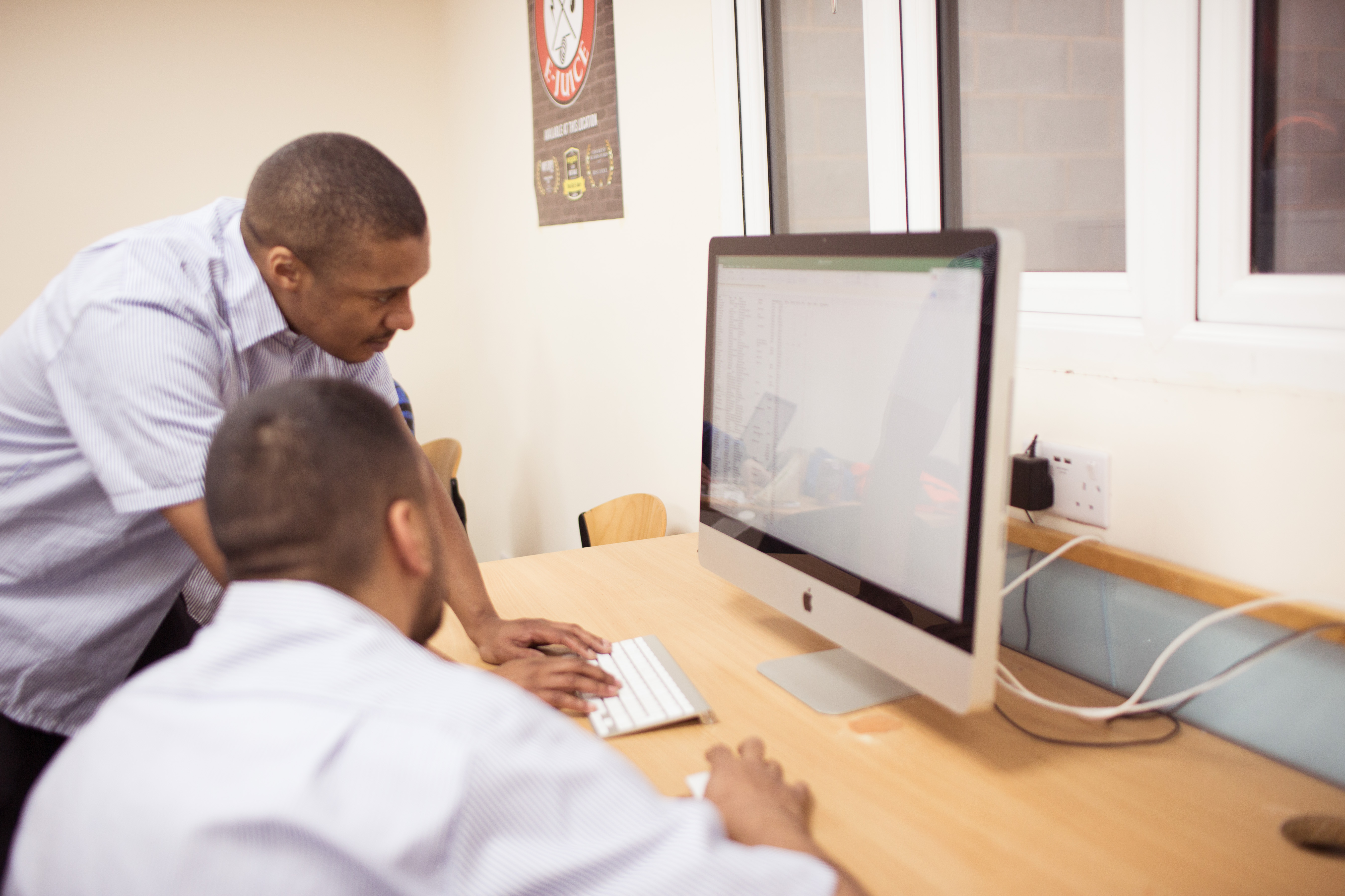 Two people looking at a computer screen